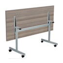 Back view of TC One Eighty rectangular tilting table in grey oak finish, showing the table's adjustable tilt mechanism and sleek design.