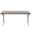 Gray oak folding rectangular table by TC with metal legs, shown in a folded position for easy storage.
