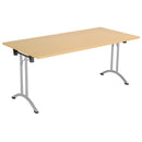 Foldable rectangular table in Nova Oak finish by TC, showing a sturdy surface and sleek folding legs for versatile use.