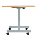 Side view of the TC One Eighty D-End Tilting Table in beech wood, showcasing its adjustable tilting mechanism and sleek design.