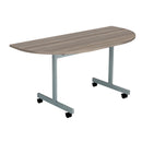 Front view of the TC One Eighty D-End Tilting Table in grey oak finish, showcasing its sleek design and tilting tabletop.