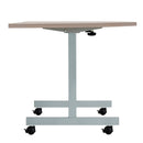 Side view of the TC One Eighty D-End tilting table in grey oak with sleek modern design.