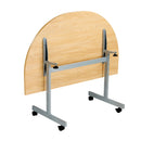 Back view of the One Eighty D-End Tilting Table in Nova Oak by TC, showcasing its tilting mechanism and wood finish.