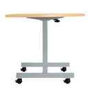 Side view of the One Eighty D-End Tilting Table in Nova Oak by TC, showcasing its sleek design and tilting mechanism.