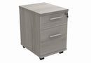 Front view of TC Core Mobile Under Desk Pedestal in Alaskan Grey Oak, showing compact storage with wheels and sleek design.