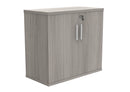 Front view of the TC Core Wooden Cupboard in Alaskan Grey Oak, showcasing its sleek wooden doors and modern design.
