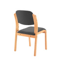 TC Renoir chair with a sleek wooden frame and cushioned fabric seat, shown from the back in a modern living room setting.