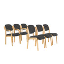 TC Renoir Chair with plush fabric upholstery and wooden legs, showcased in a modern living room setting.