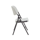 White Morph folding chair by TC, shown from side angle, featuring a sleek modern design and lightweight frame.