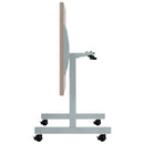 Grey oak One Eighty Trapezoidal Tilting Table by TC with adjustable angles and modern design for versatile workspace setup.
