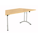 Trapezoidal folding table by TC with Nova Oak finish, featuring a sturdy design and convenient foldable structure.
