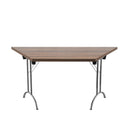 Walnut TC One Union trapezoidal folding table, showing its sturdy wooden surface and foldable metal legs for easy storage.