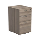 Front view of TC 3 Drawer Under Desk Pedestal in Grey Oak finish, featuring three drawers and a compact design for office storage.