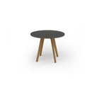 Dams Unity circular dining table with solid oak legs in onyx grey finish, showcasing a sleek modern design and smooth tabletop surface.