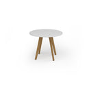 White Unity circular dining table with solid oak legs by Dams, featuring a modern design and smooth surface.