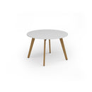 Unity circular dining table with solid oak legs in white, designed by Dams, showcasing a modern and sleek kitchen or dining room setup.