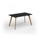 Black Unity dining table with solid oak legs by Dams, showcasing its sleek tabletop and sturdy wooden legs in a modern design.