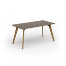 Dams Unity dining table with Nebraska oak top and solid oak legs, showcasing a sleek modern design in a dining room setting.