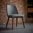 Aztec side chair by ZAP with faux leather upholstery, showcasing a modern design with a sleek, sculpted shape on a neutral background.