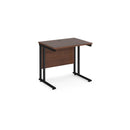 Dams Maestro 25 600mm deep walnut straight desk with black cantilever legs, showing the sleek wooden tabletop and modern design.