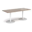 Rectangular dining table with flat round base in Barcelona walnut wood by Dams, showcasing a modern kitchen or dining room setup.