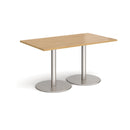 Dams Monza rectangular oak dining table with a flat round base, showcasing a sleek and modern design.
