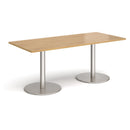 Dams Monza rectangular oak dining table with a flat round base, modern design, on a smooth wooden floor.