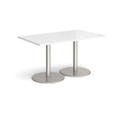 White Monza rectangular dining table by Dams with a flat round base, modern design, shown in a well-lit dining room setting.