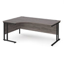 Dams Maestro 25 ergonomic desk with grey oak finish and cantilever legs, shown from the left side.