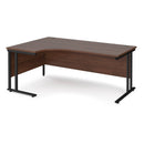 Dams Maestro 25 ergonomic desk with walnut finish and cantilever leg, shown from the left side with black frame.