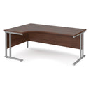 Dams Maestro 25 ergonomic desk with walnut finish and cantilever leg, shown from the left side, featuring a spacious workspace.