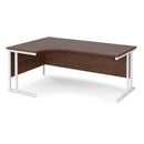Dams Maestro 25 ergonomic desk with walnut finish and cantilever leg, shown from the left side with white accents.