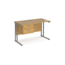 Dams Maestro 25 straight desk with oak silver finish, 600mm depth, fixed 2-drawer pedestal, and cantilever legs.