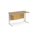 Dams Maestro 25 straight desk with white oak finish, 600mm deep, fixed 2-drawer pedestal, and cantilever legs for office workspace.