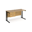 Dams Maestro 25 straight desk with oak-black finish, 600mm depth, fixed 2-drawer pedestal, and cantilever legs.