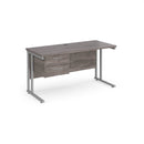 Dams Maestro 25 straight desk in grey oak with silver finish, 1400mm wide, 600mm deep, featuring fixed 2-drawer pedestal and cantilever legs.