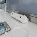 Dams Chroma clip-on power module with UK sockets, twin USB fast charge ports, and RJ45 Ethernet sockets attached to a desk.