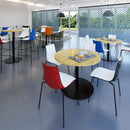 White Monza circular poseur table with central circular cut-out, designed by Dams, shown in a modern setting.