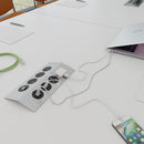 Dams Tholus in-table power module with 4 UK sockets, USB charger, RJ45 and HDMI ports in brushed steel and black finish.