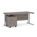 Dams Maestro 25 straight desk with grey oak finish and matching 3-drawer under desk pedestal for modern office setup.