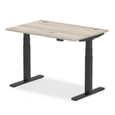 Dynamic Air 800mm deep height adjustable desk in grey oak with cable ports, featuring a modern design and functional workspace.