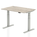Gray oak Air 800mm deep height adjustable desk by Dynamic with cable ports, featuring sleek modern design and ergonomic functionality.