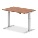 Dynamic Air 800mm deep height adjustable desk with walnut finish and cable ports, featuring a sleek, modern design.