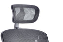 Black mesh Mirage II executive office chair by Dynamic with armrests and adjustable headrest, ergonomic and modern design.
